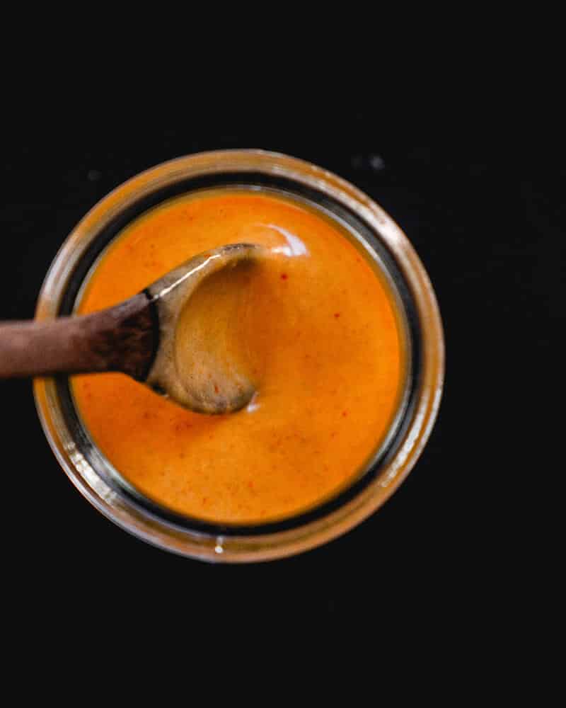 spoon in jar of chipotle sauce