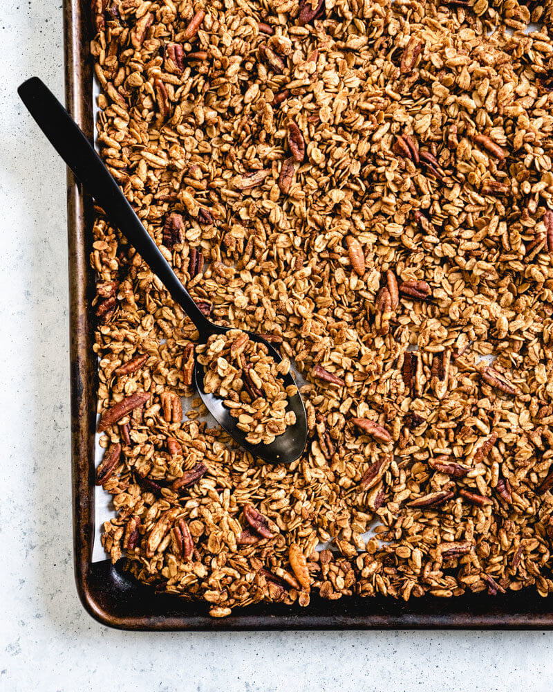 Spoon on baking sheet of healthy granola