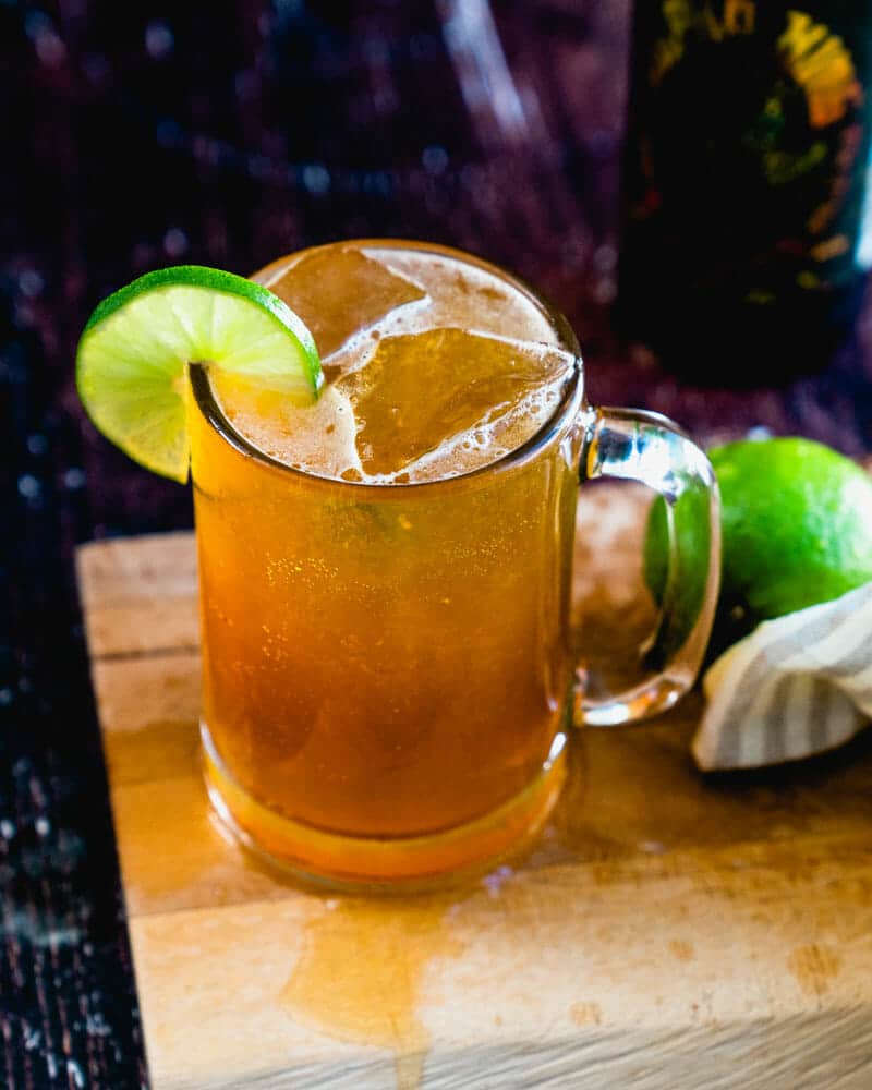 Beergarita in glass mug with lime and clear ice.