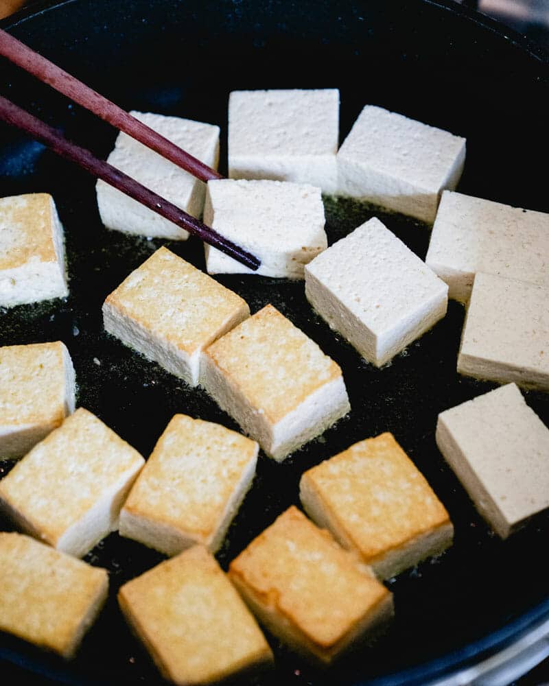 Flip the tofu with chopsticks