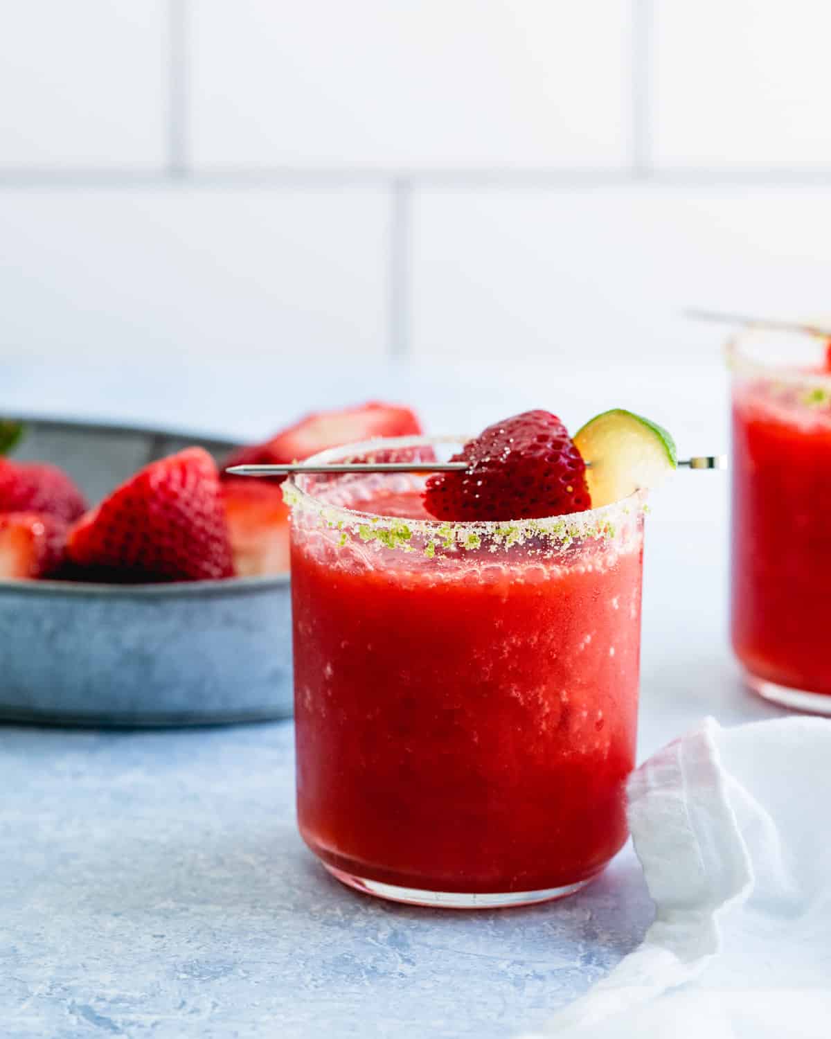 How to make a strawberry margarita: margarita glass with strawberry garnish