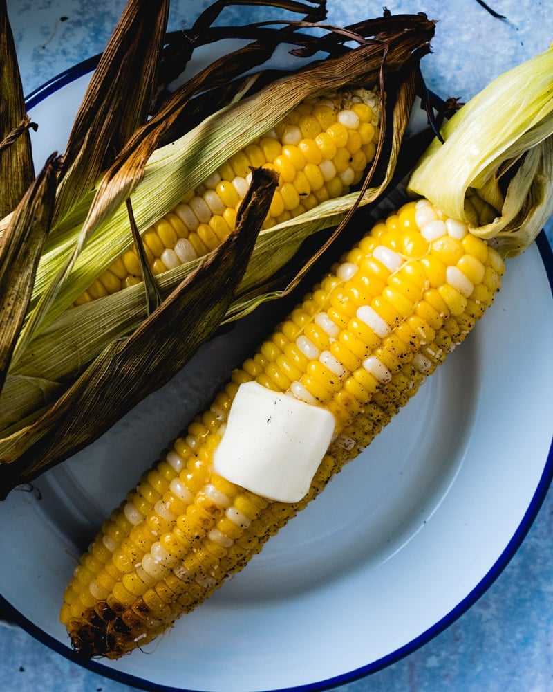 Grilled corn on the cob in husk