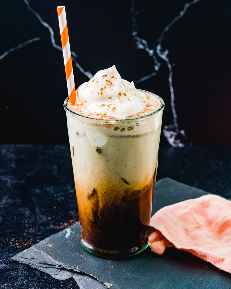 Iced Pumpkin Spice Latte in cup with orange striped straw