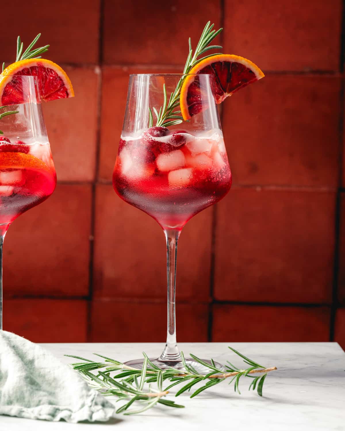 Thanksgiving cocktail or Christmas cocktail in glass with rosemary garnish