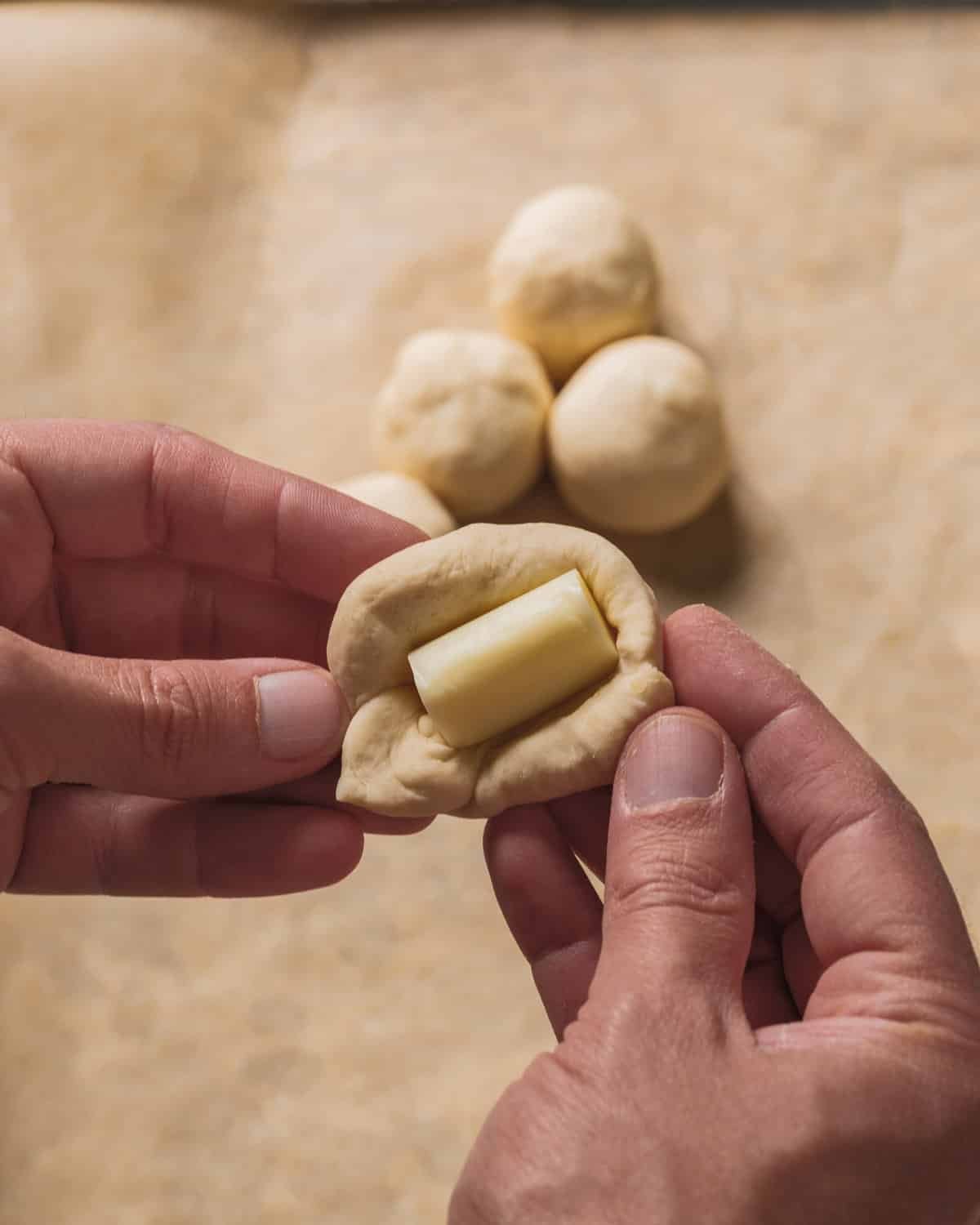 Place the cheese inside the dough ball