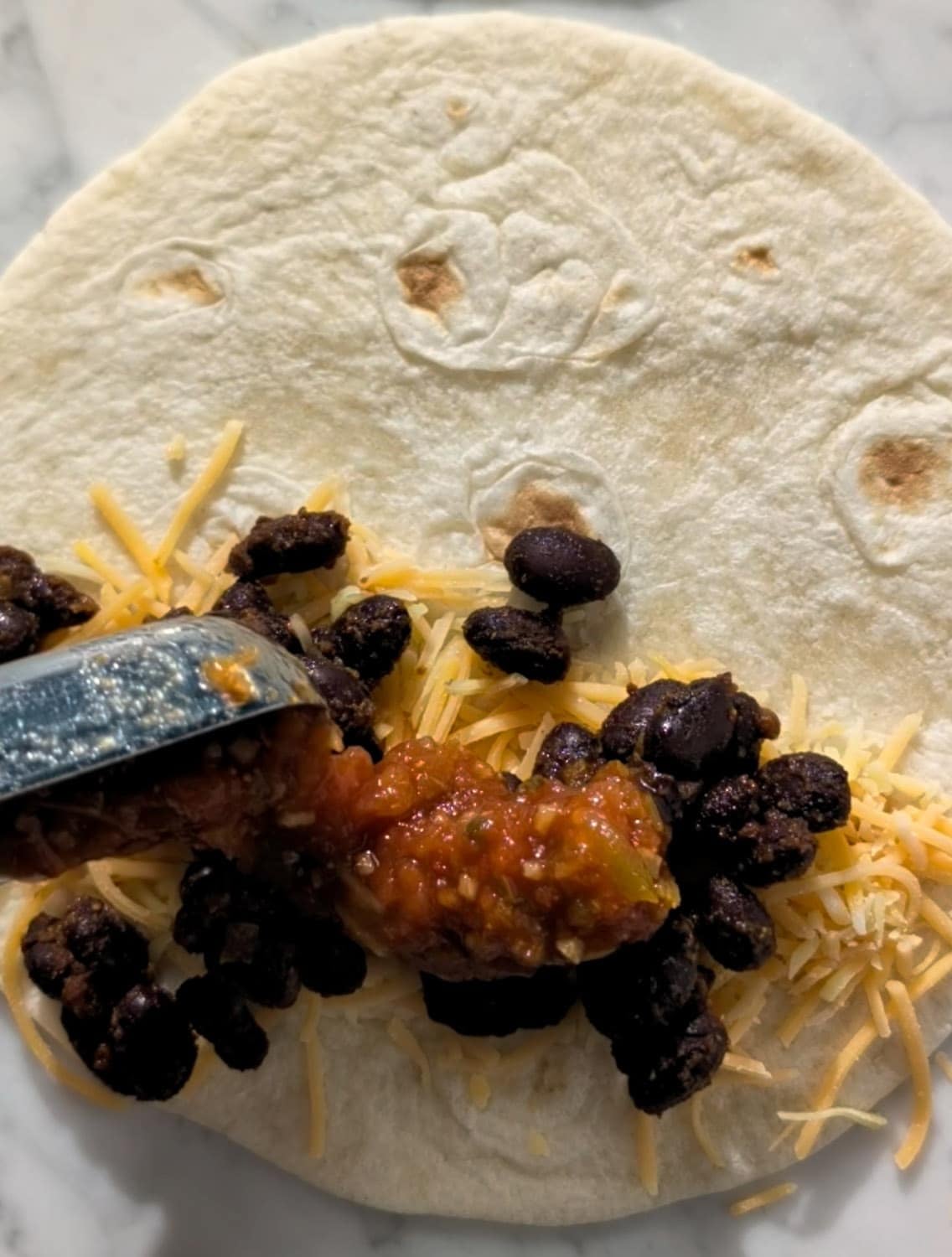 Crispy Black Bean Tacos adding the filling